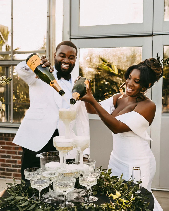 Couple pouring champagne at their celebration